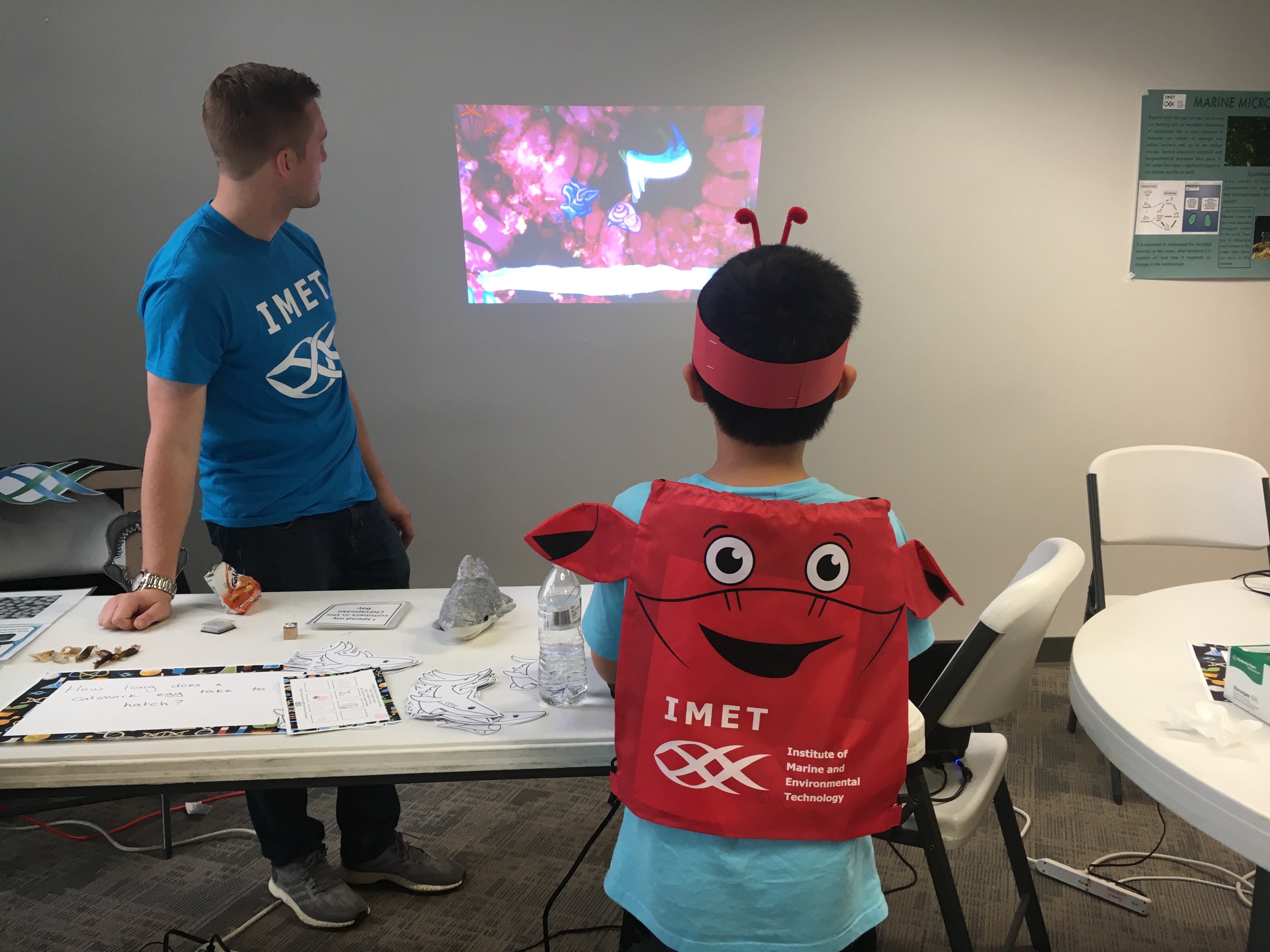 child wearing a crab headband playing a video game