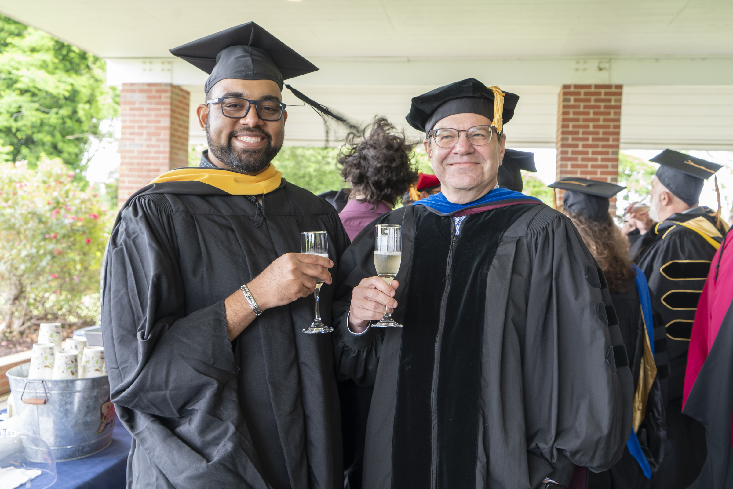 Image of Ben Frey and Dr. Dave Secor smiling at commencement