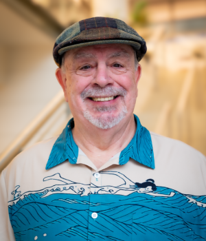 A professional headshot of Al Place in the IMET lobby