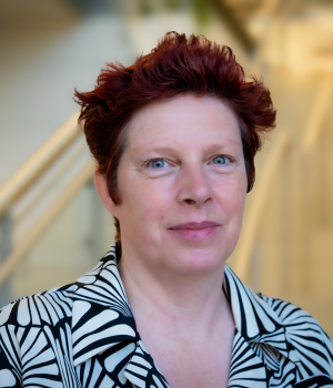 A professional headshot of Helen in the IMET lobby