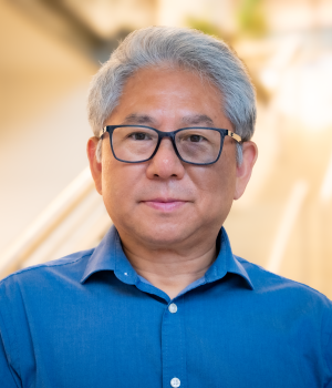 A professional headshot of Jim Du in the IMET lobby
