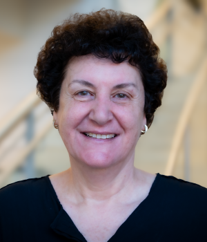A professional headshot of Nilli Zmora in the IMET lobby