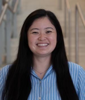 A professional headshot of Ally in the IMET lobby