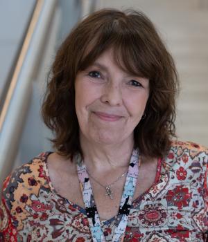 A professional headshot of Jacqui in the IMET lobby