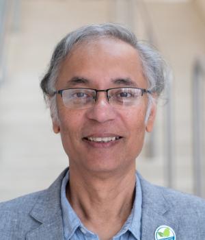 A professional headshot of Shil DasSarma in the IMET lobby