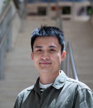 A professional headshot of Yalong Sun in the IMET lobby 