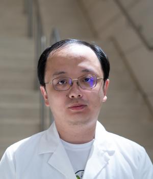 A professional headshot of Yang Yu in the IMET lobby 