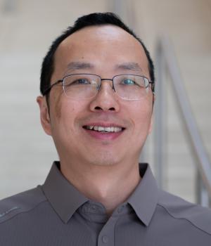 A professional headshot of Yantao Li in the IMET lobby
