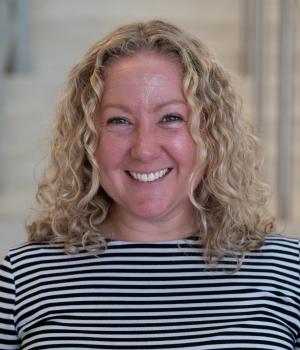 A professional headshot of Amy in the IMET Lobby