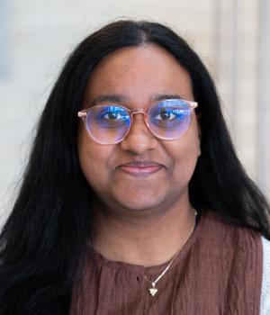 A professional headshot of Bibi in the IMET Lobby