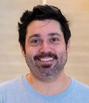 A professional headshot of Cody in the IMET lobby