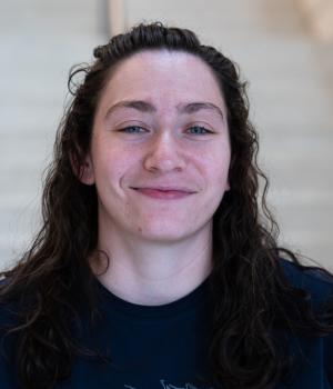 A professional headshot of Emma in the IMET lobby