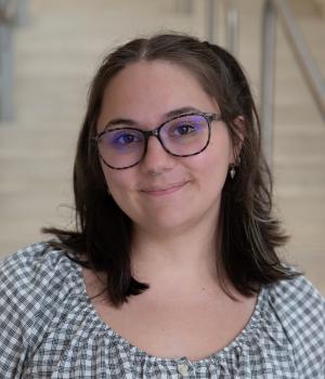 A professional headshot of Gina in the IMET lobby