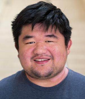 A professional headshot of Jeffery in the IMET lobby