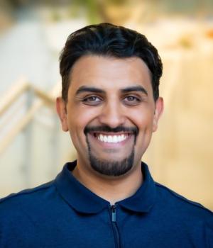 A professional headshot of Majeed in the IMET lobby