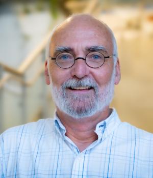 A professional headshot of Michael Yates in the IMET lobby