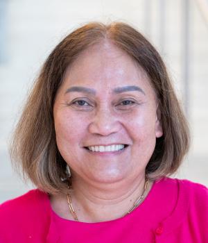 A professional headshot of Mildred in the IMET lobby