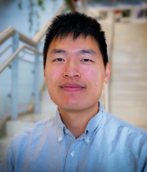 A professional headshot of Yufeng in the IMET Lobby