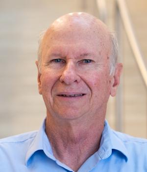 A professional headshot of Russell in the IMET lobby