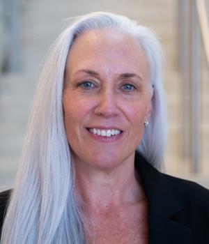A professional headshot of Stephanie in the IMET lobby
