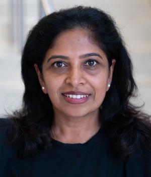 A professional headshot of Sabeena in the IMET lobby