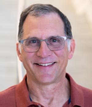 A professional headshot of Steve in the IMET lobby