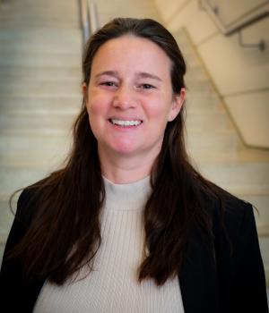 A professional headshot of Taylor in the IMET lobby