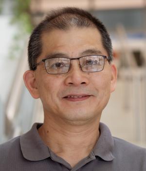 A professional headshot of Ten-Tsao Wong in the IMET lobby