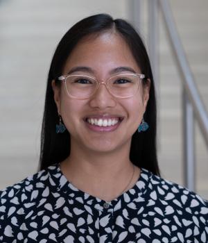 A professional headshot of Tessa in the IMET lobby