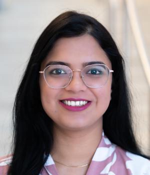 A professional headshot of Vedangi in the IMET lobby