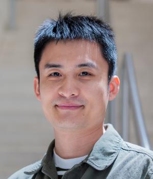 A professional headshot of Yalong in the IMET lobby