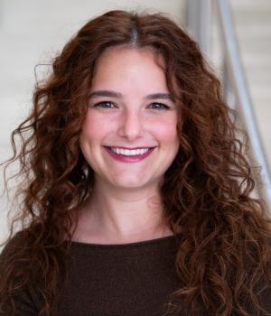 A professional headshot of Morgan in the IMET lobby