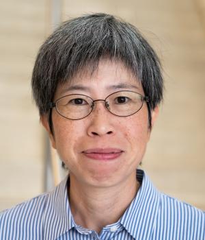 A professional headshot of Yi-Ying Lee in the IMET lobby