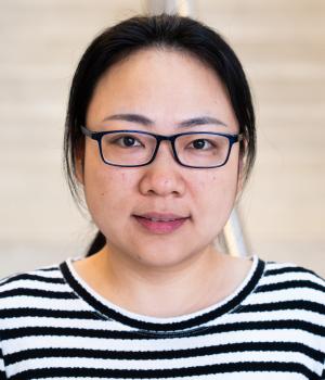 A professional headshot of Shuxian in the IMET lobby