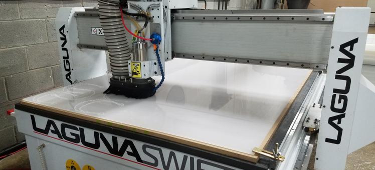 large machine cutting plastic from a sheet