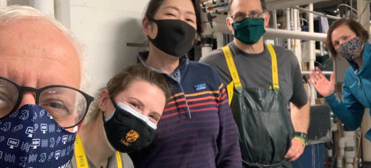 5 people in masks in the Aquaculture Research Center