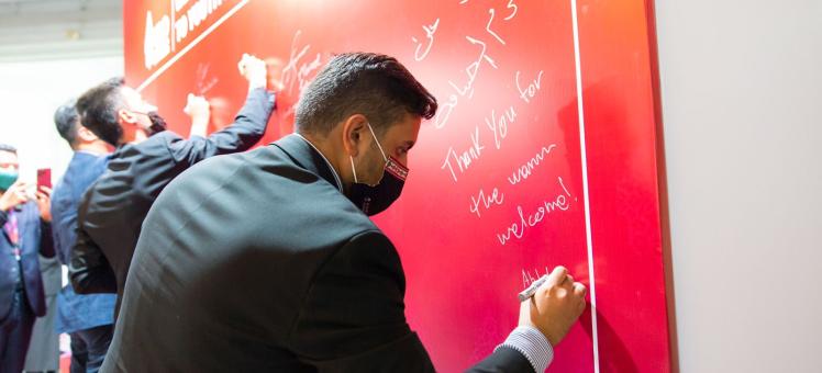Majeed Alrefaie at the Y20 Summit in Indonesia adding his signature to a red poster