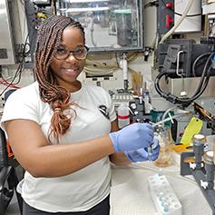 Jeanette Davis in a lab with a NOAA t-shirt