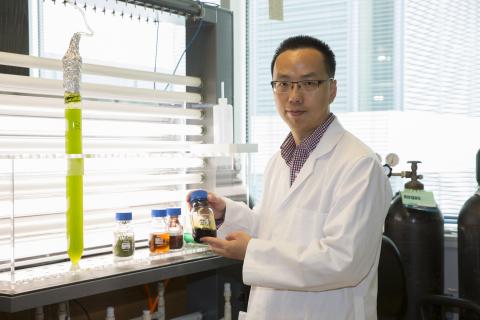 Image of Dr. Yantao Li holding a beaker in a laboratory