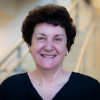 A professional headshot of Nilli Zmora in the IMET lobby