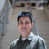 A professional headshot of Yalong Sun in the IMET lobby 