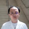 A professional headshot of Yang Yu in the IMET lobby 