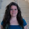 A professional headshot of Kristina in the IMET lobby