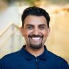 A professional headshot of Majeed in the IMET lobby