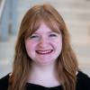 A professional headshot of Emily in the IMET lobby