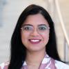 A professional headshot of Vedangi in the IMET lobby