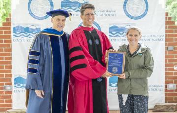 Image of Dr. Eric Schott receiving outstanding faculty mentor award at UMCES commencement