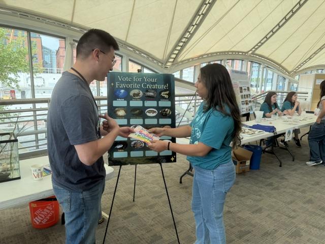 Ronita presenting a poster board at the 2026 IMET Open House